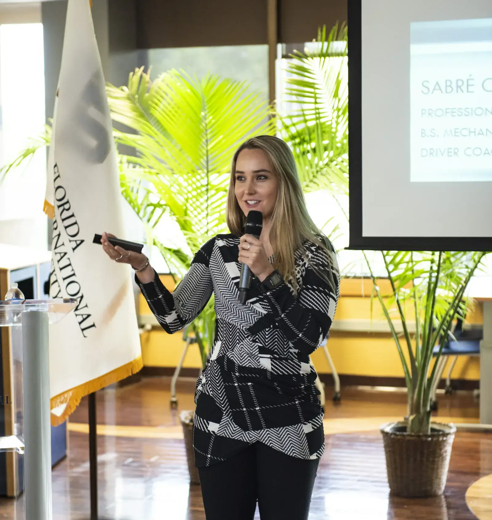Sabré speaking at an event