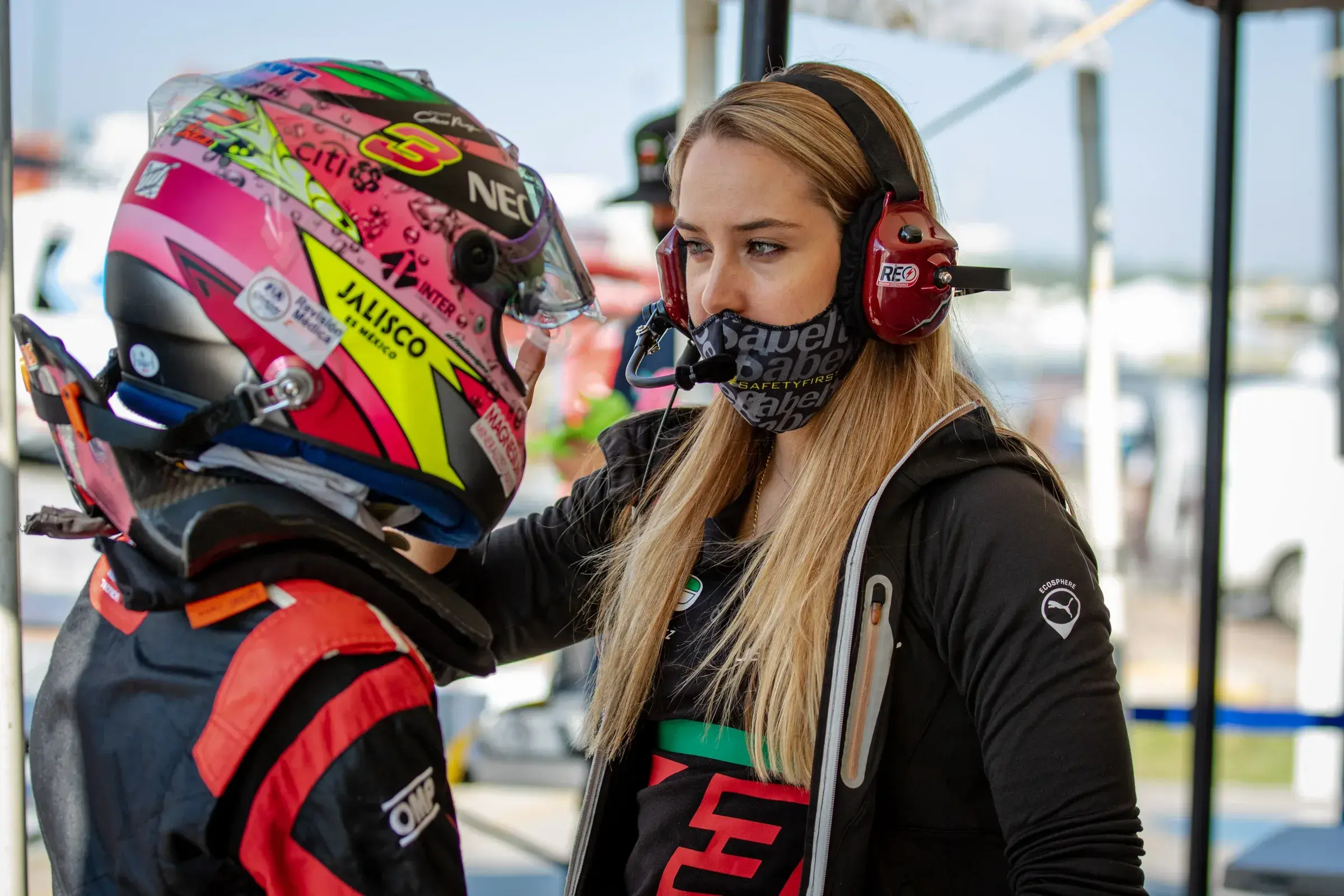 Sabré Cook coaching a fellow racing driver, providing instruction and mentorship