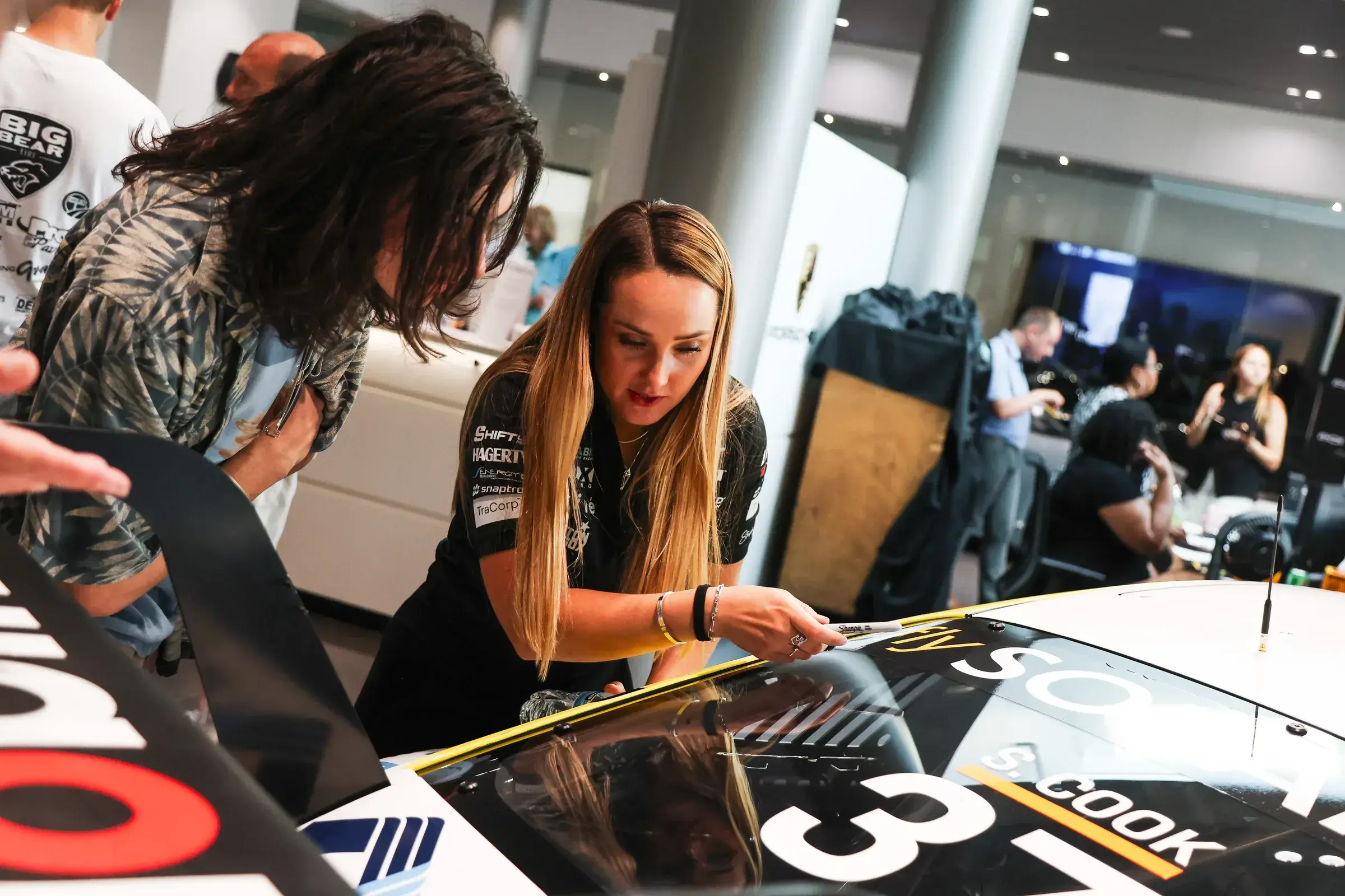 Sabré walks an attendee through her Porsche's components at Porsche Milwaukee North.
