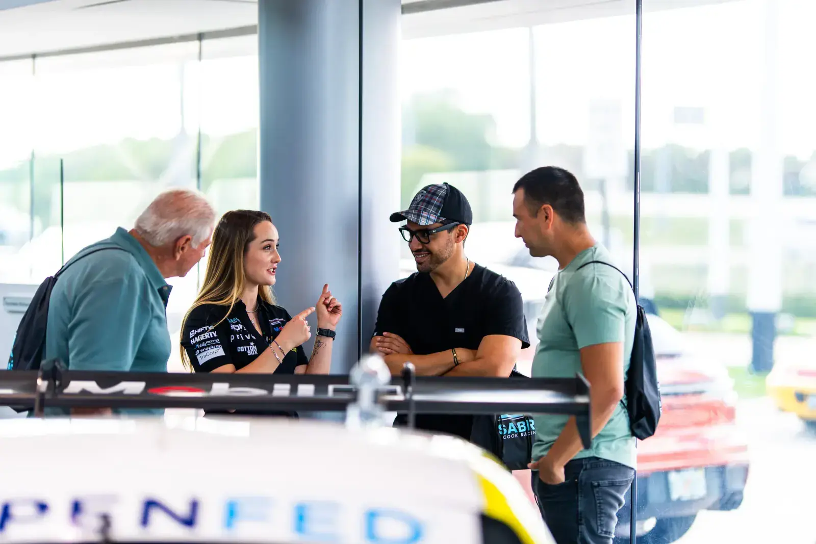 Sabré interacting with guests at an automotive event