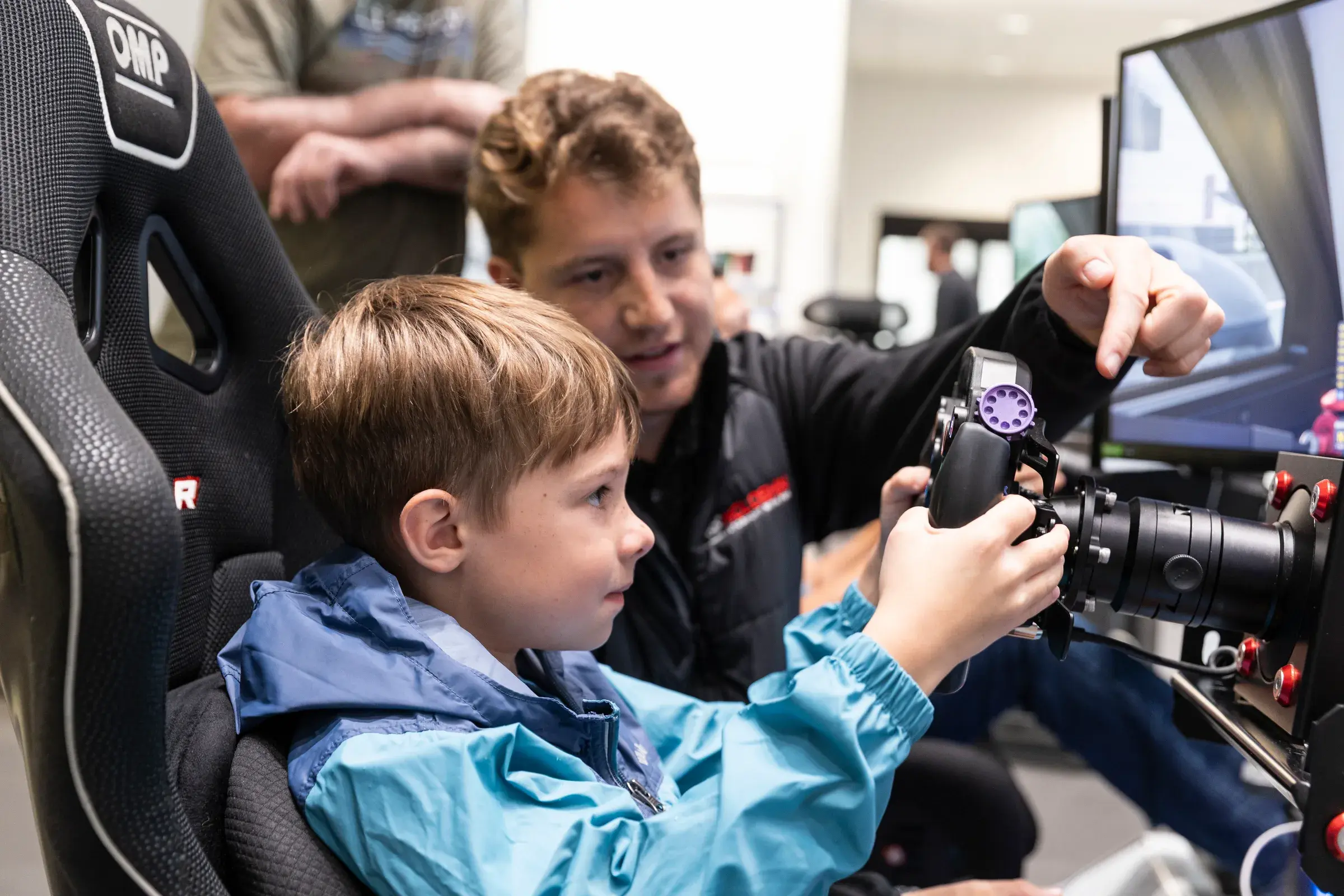 An attendee tries the reaction training setup at Tow Wood Porsche.