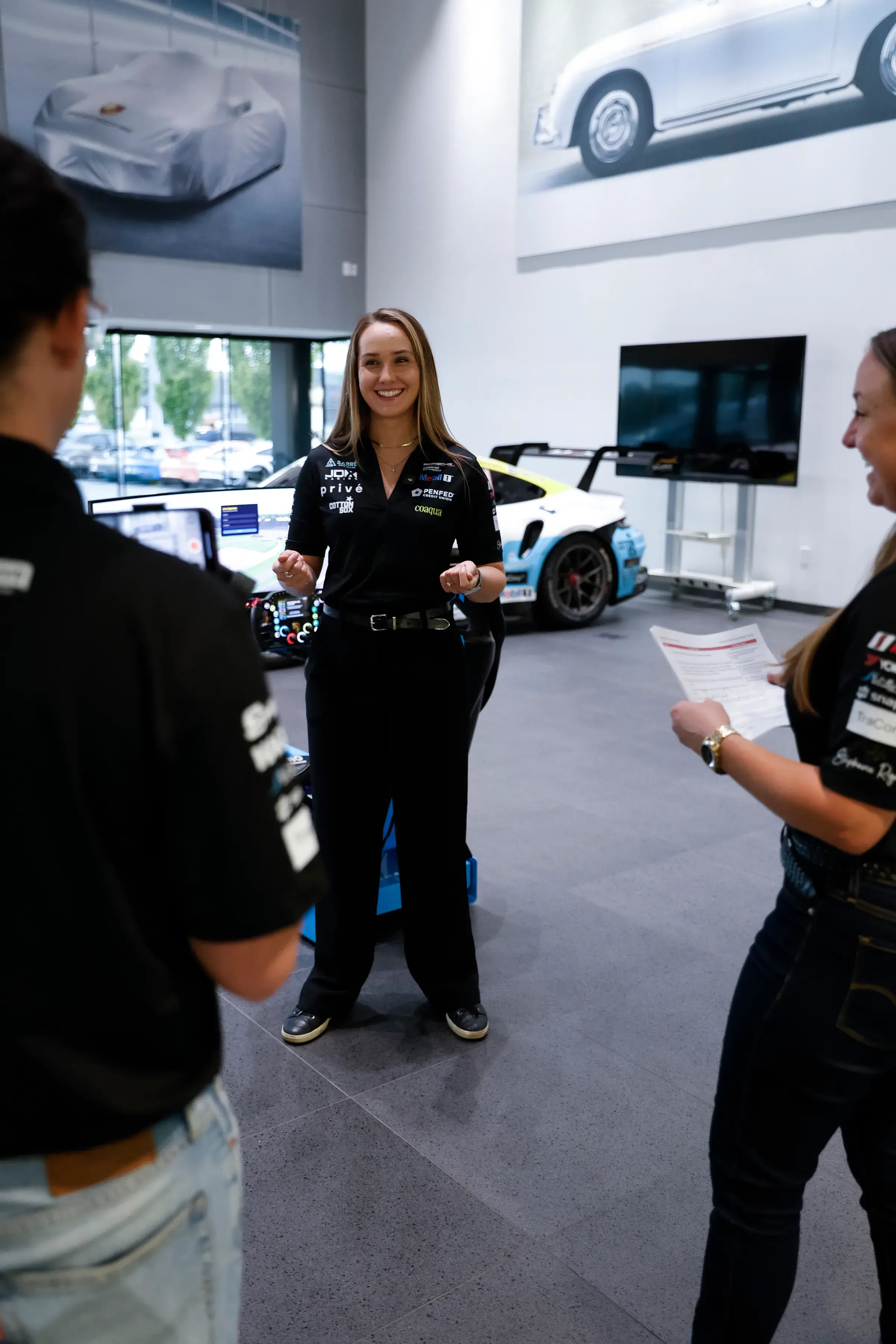 Sabré walks an attendee through the reaction training setup at Tow Wood Porsche.