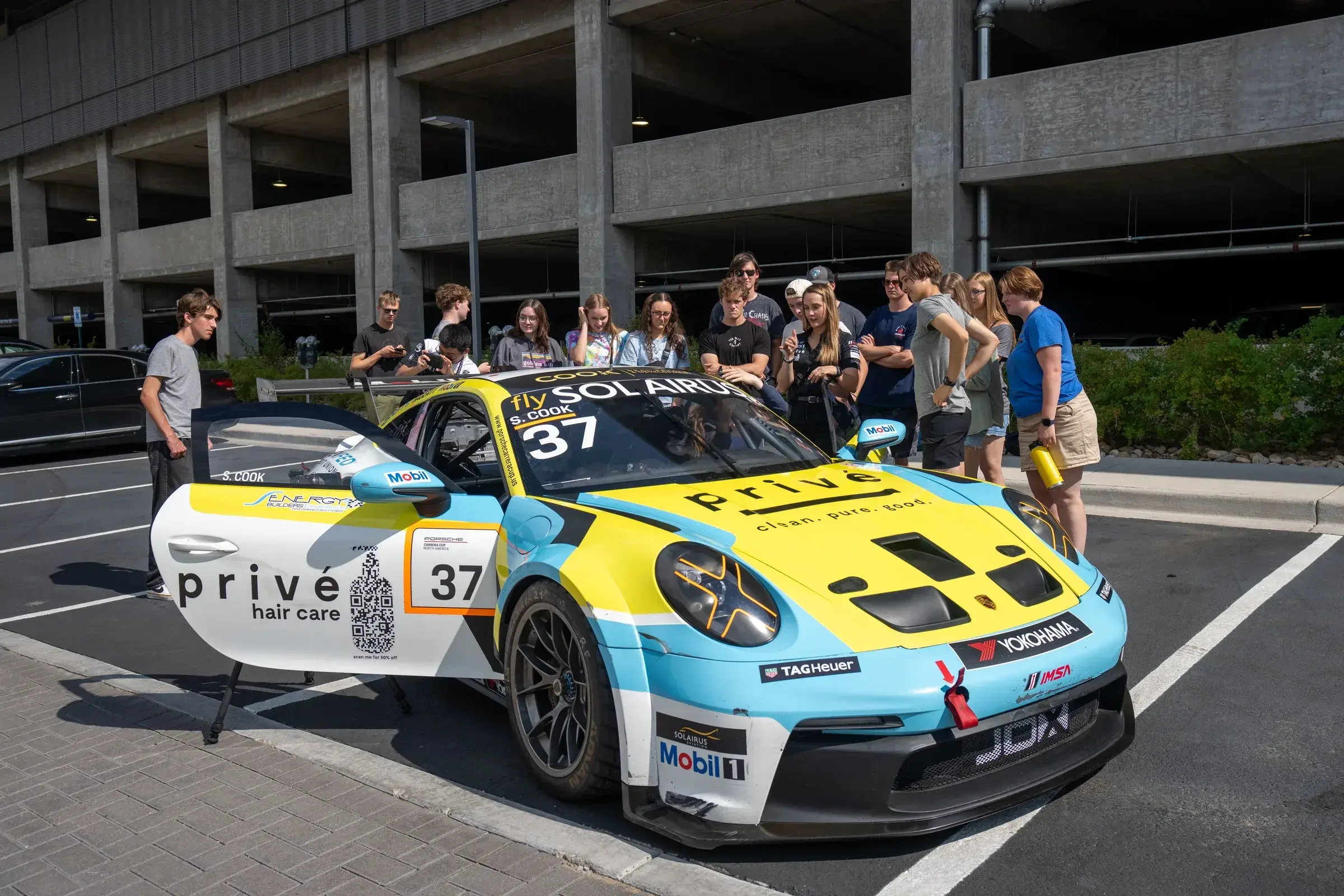 Sabré talks about her Porsche with students gathered around it at the Colorado School of Mines.