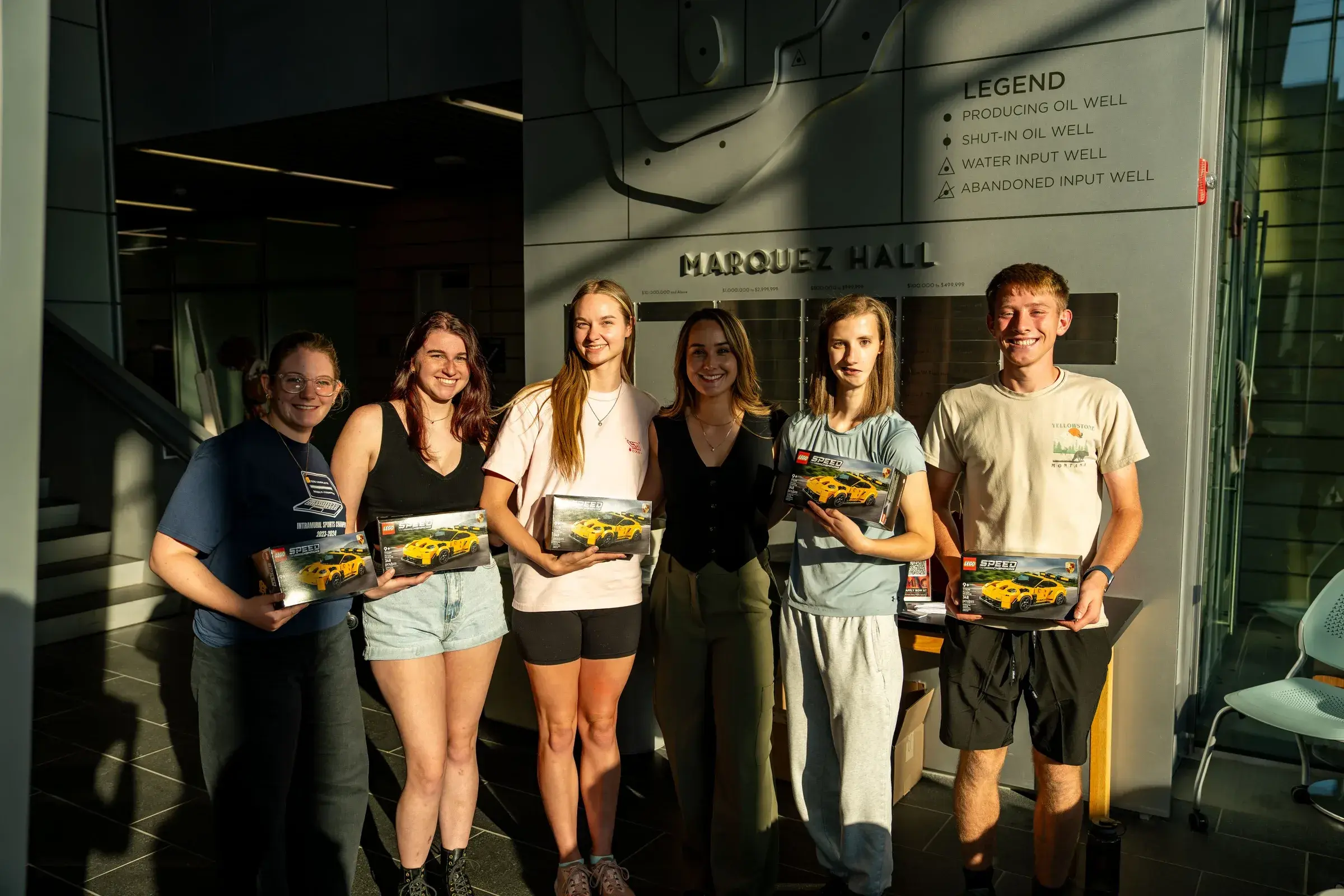 Sabré posing with students in Marquez Hall at the Colorado School of Mines.