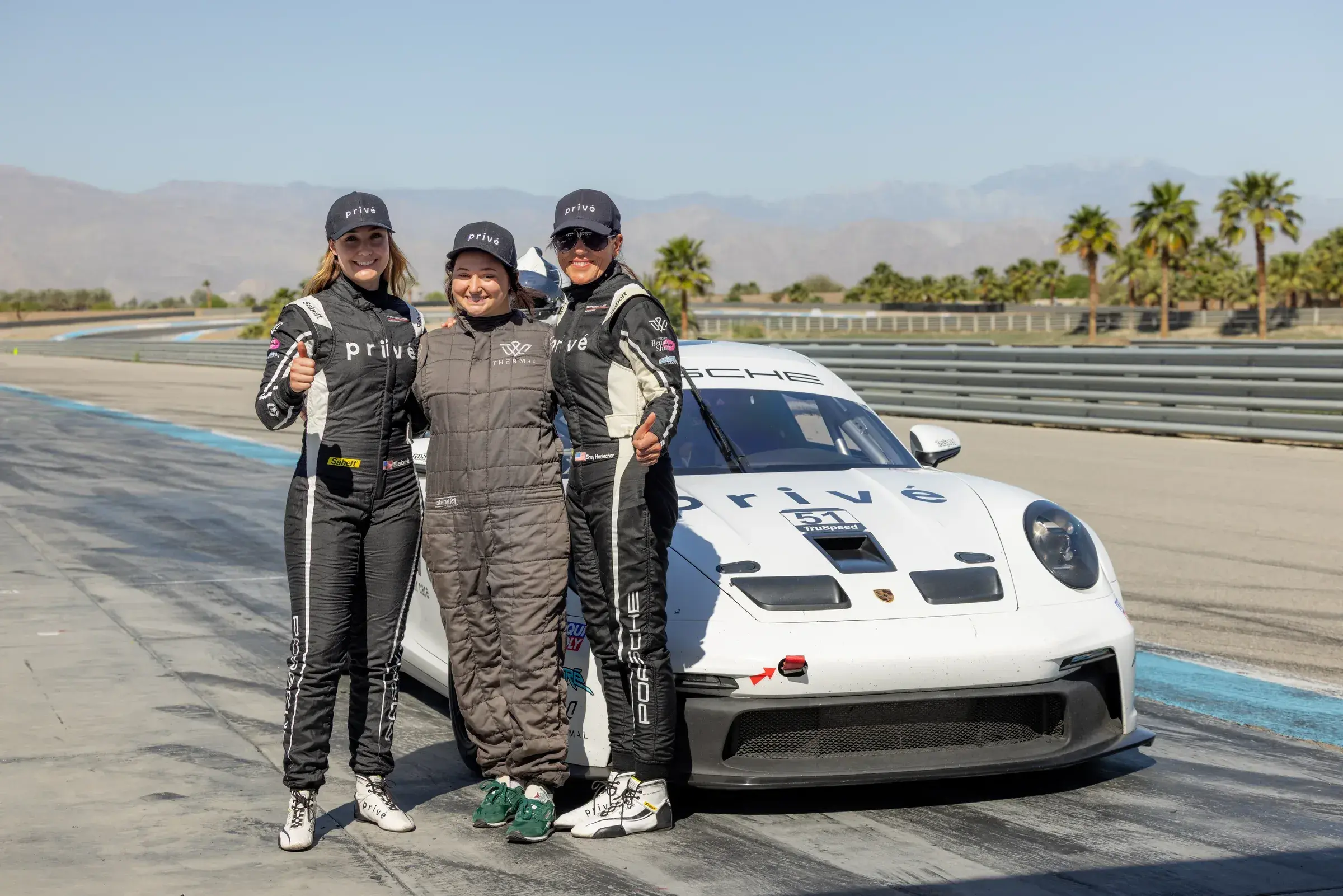 Sabré and Shay pose with a Privé guest before the guest ride experience.